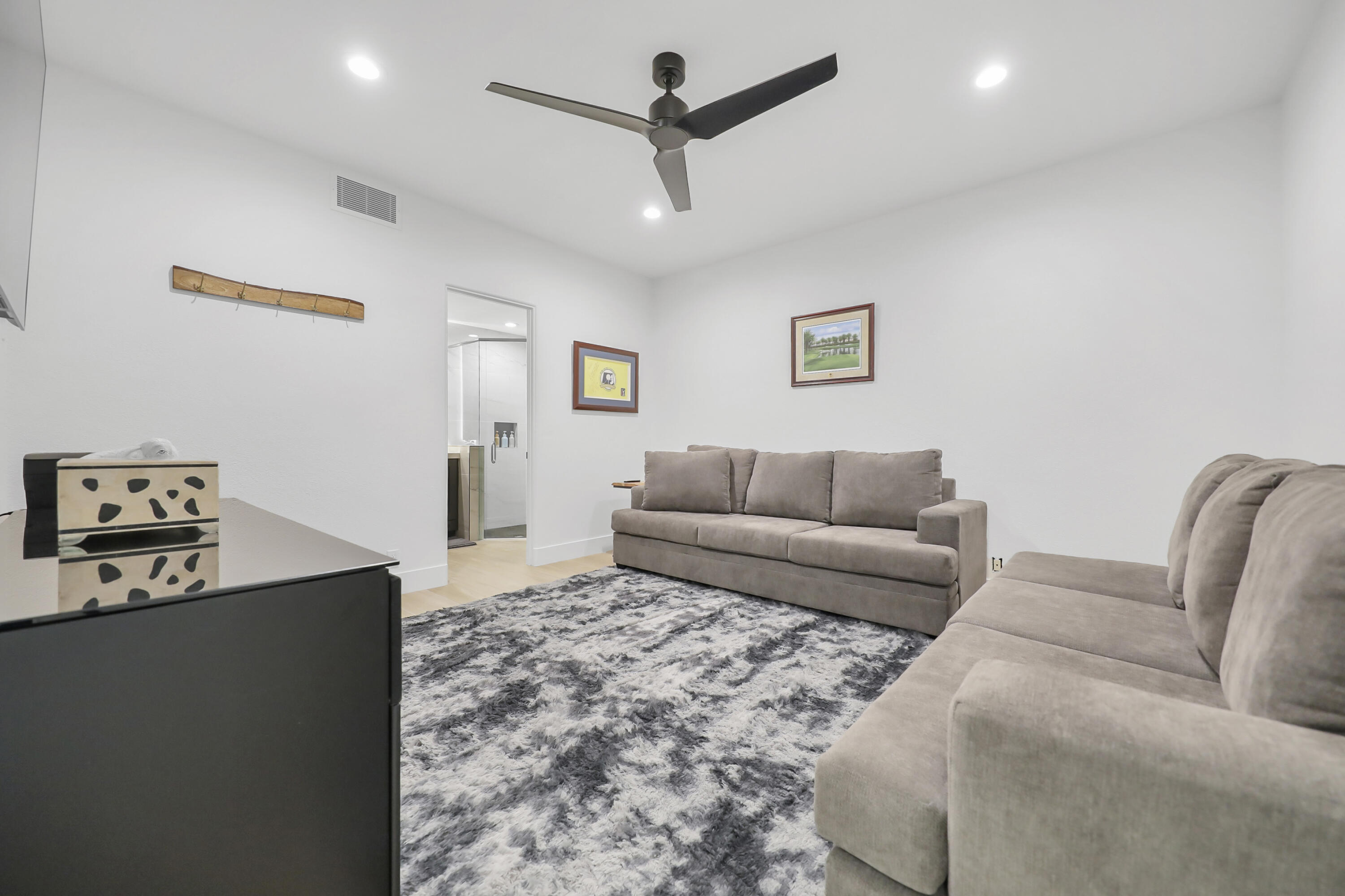 79754 Arnold Palmer La Quinta, CA 92253 - Photo 22 of 38 a living room with furniture a ceiling fan and a rug