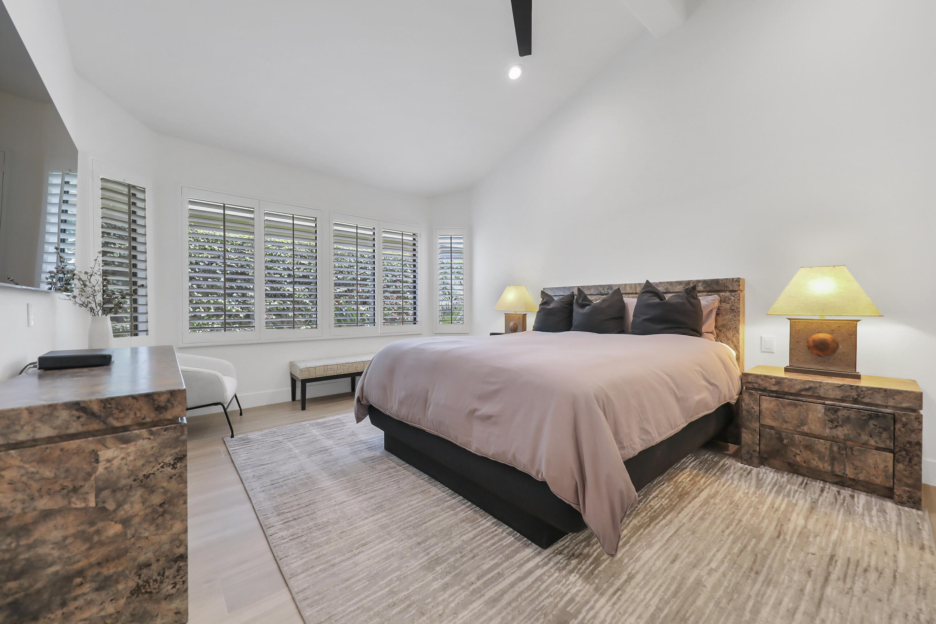 79754 Arnold Palmer La Quinta, CA 92253 - Photo 25 of 38 a spacious bedroom with a bed and wooden floor