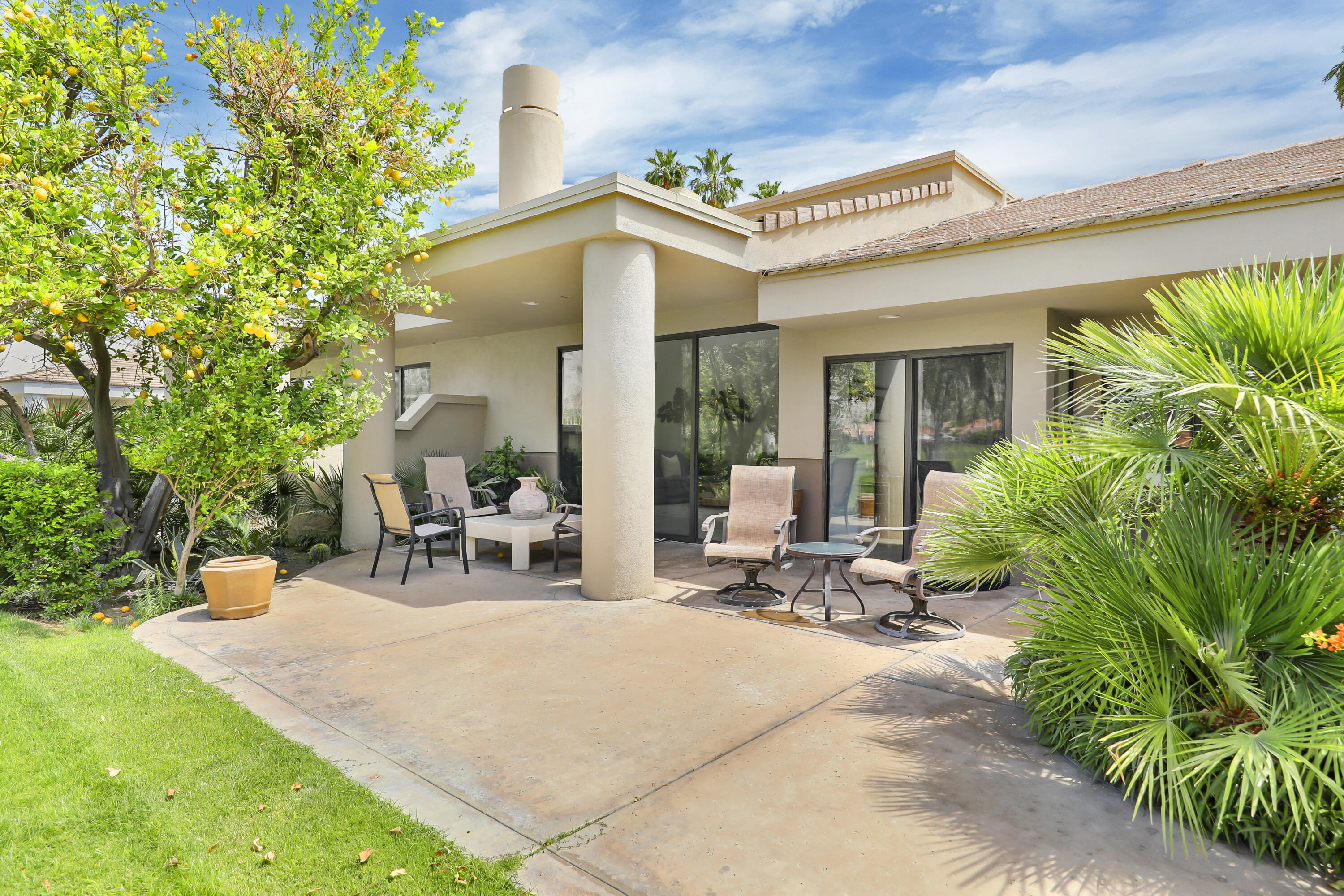 79754 Arnold Palmer La Quinta, CA 92253 - Photo 33 of 38 a view of a patio with table and chairs and potted plants