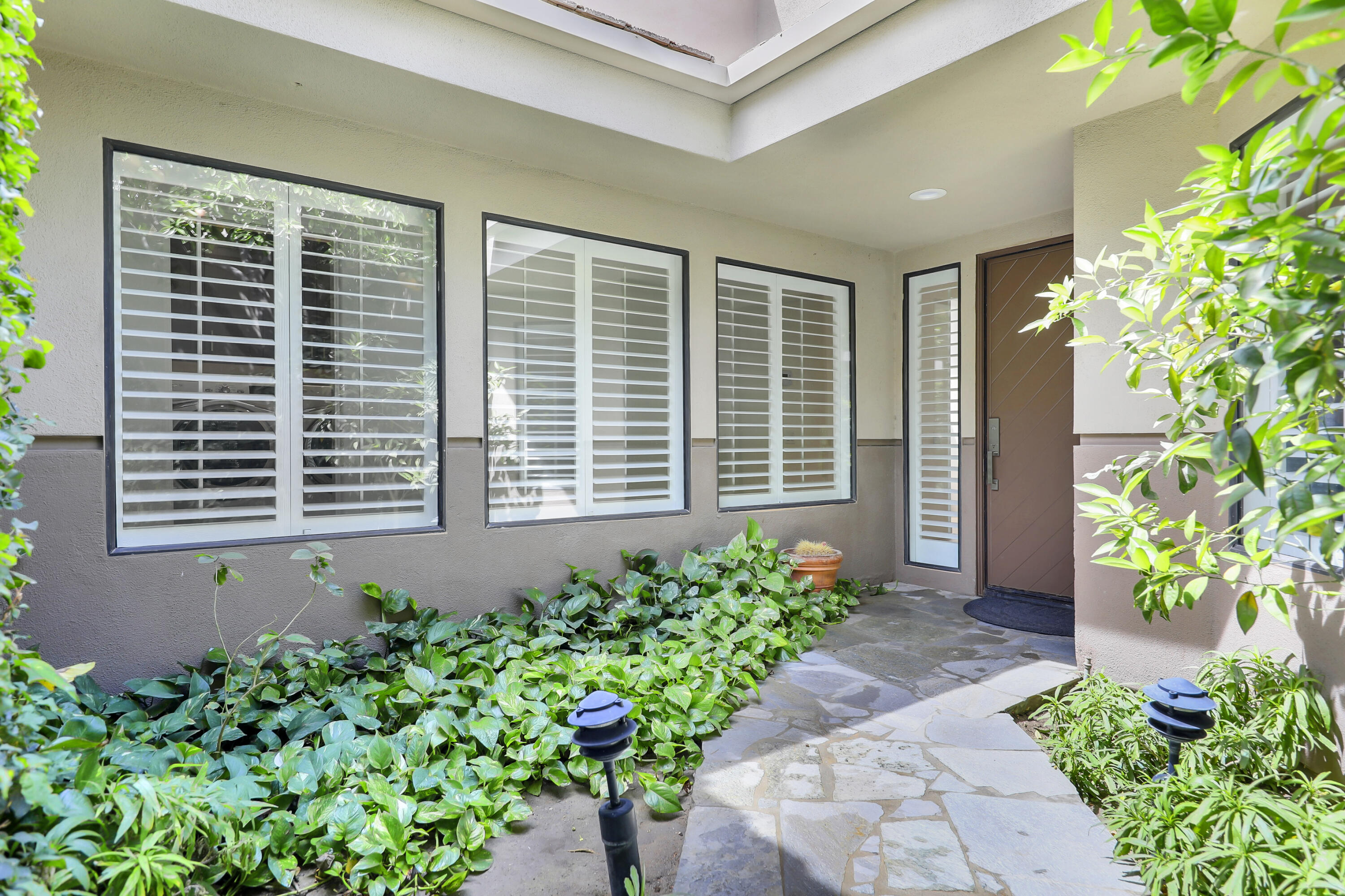 79754 Arnold Palmer La Quinta, CA 92253 - Photo 4 of 38 a view of a house with a flower garden