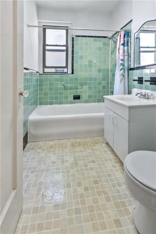 351 Marine Avenue, Unit E18 Brooklyn, NY 11209 - Photo 11 of 13 a bathroom with a granite countertop toilet a sink and a bathtub