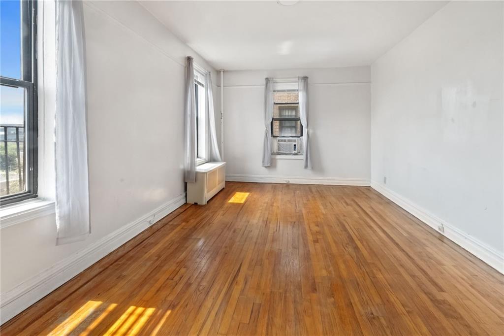 351 Marine Avenue, Unit E18 Brooklyn, NY 11209 - Photo 3 of 13 a view of wooden floor and windows in a room