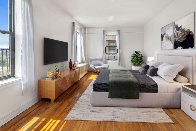351 Marine Avenue, Unit E18 Brooklyn, NY 11209 - Photo 4 of 13 a living room with furniture and a flat screen tv