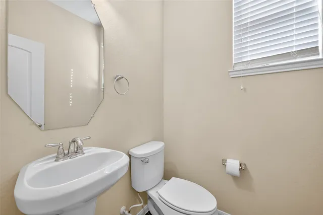 a white toilet sitting next to a bathroom sink