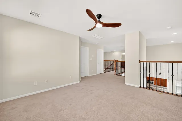 a view of a livingroom with a ceiling fan and a rug