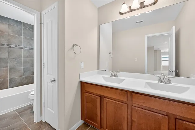 a bathroom with a double vanity sink and mirror