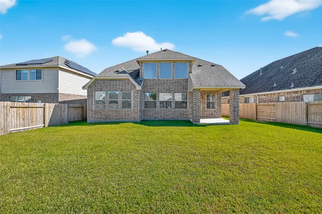 a front view of a house with a garden and yard