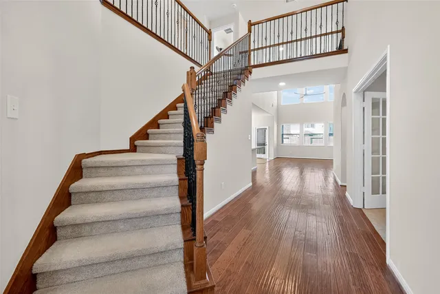 a view of entryway and hall with wooden floor