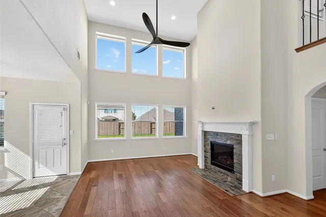 a view of empty room with wooden floor and fireplace