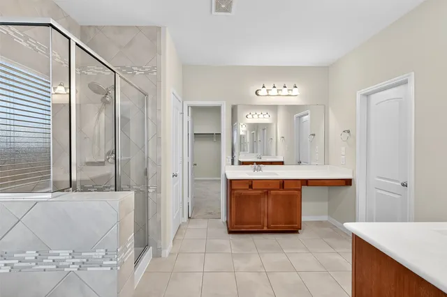 a large bathroom with a tub a double vanity sink and a mirror