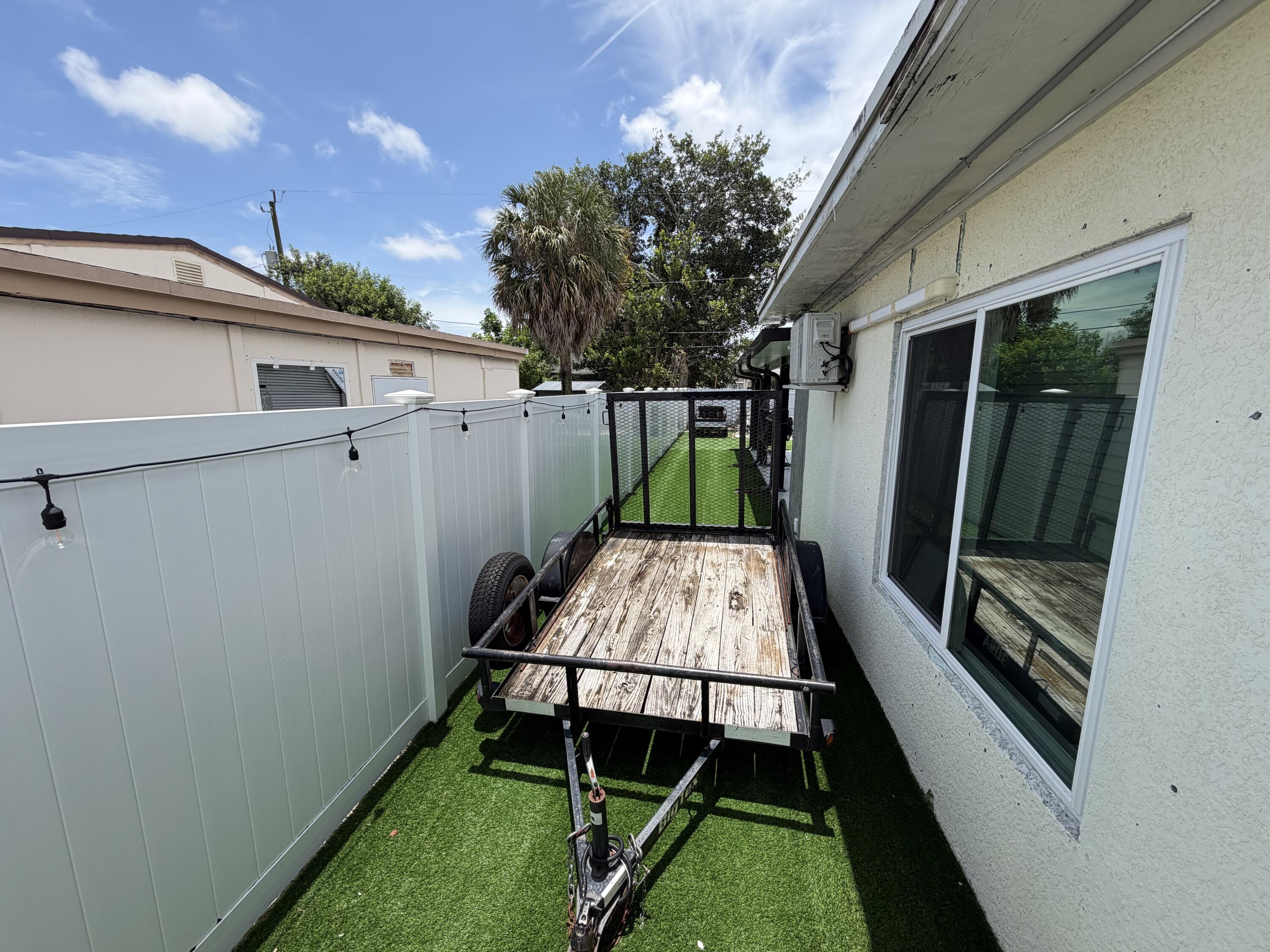 2016 Kenwood Road West Palm Beach, FL 33409 - Photo 4 of 4 a view of backyard with a tub and wooden fence