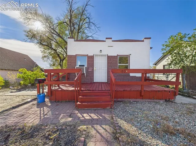a view of a backyard with sitting area