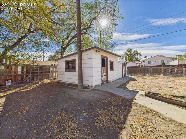 a view of a backyard with large trees