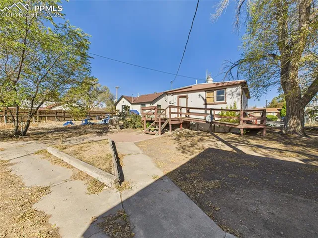 a view of a yard with cars
