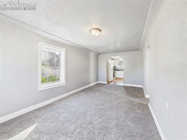 an empty room with windows and closet