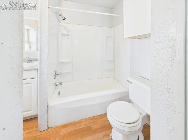 a bathroom with a toilet and a bathtub