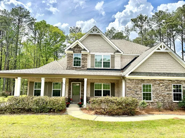 a front view of house with yard and green space