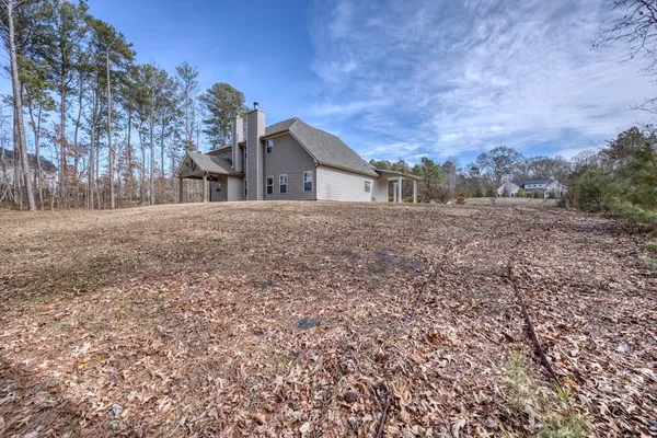an aerial view of a house with a yard