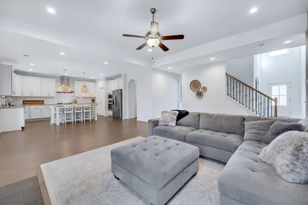 a living room with furniture and kitchen view