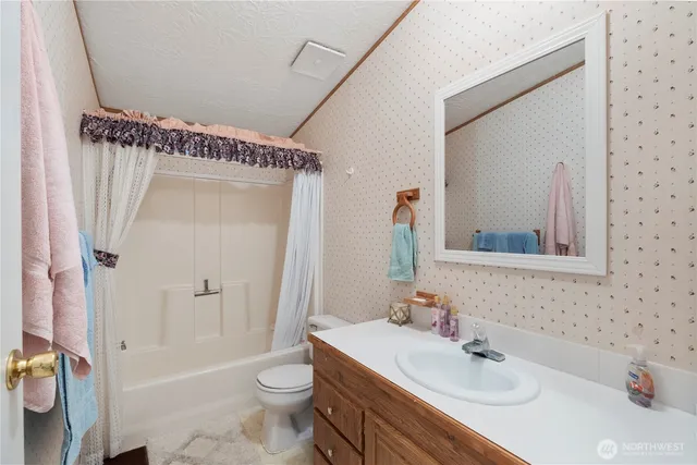 a bathroom with a sink toilet tub and shower