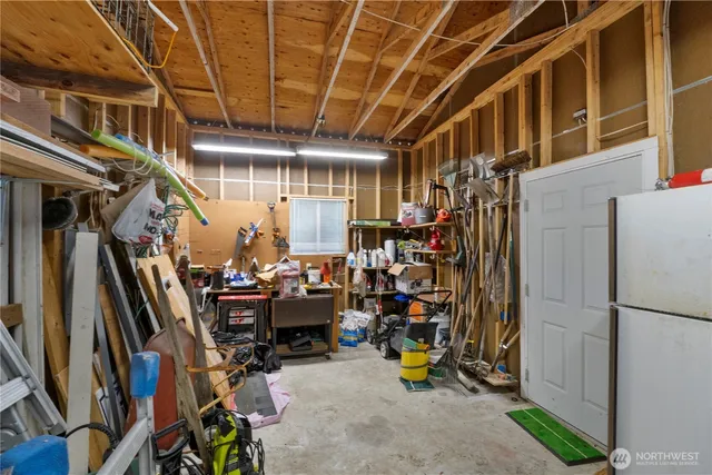 a view of a street with potted plants and large trees
