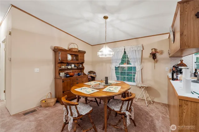 a view of a dining room with furniture and window