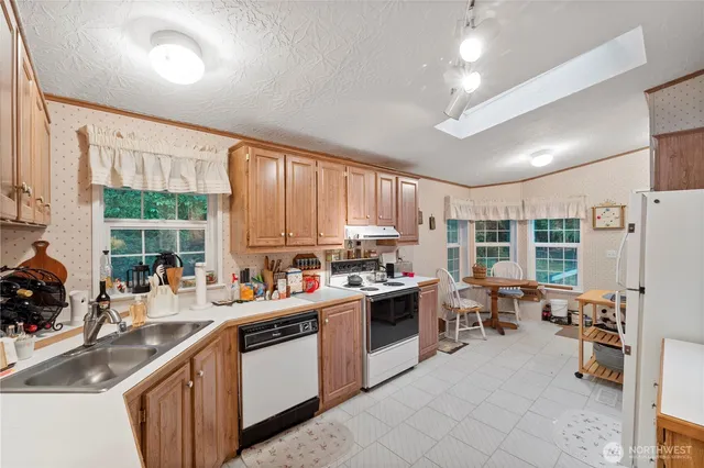 a kitchen with a sink stove and cabinets