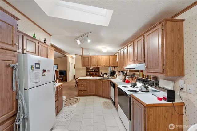 a kitchen with refrigerator and cabinets