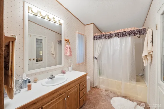 a bathroom with a double vanity sink mirror and shower