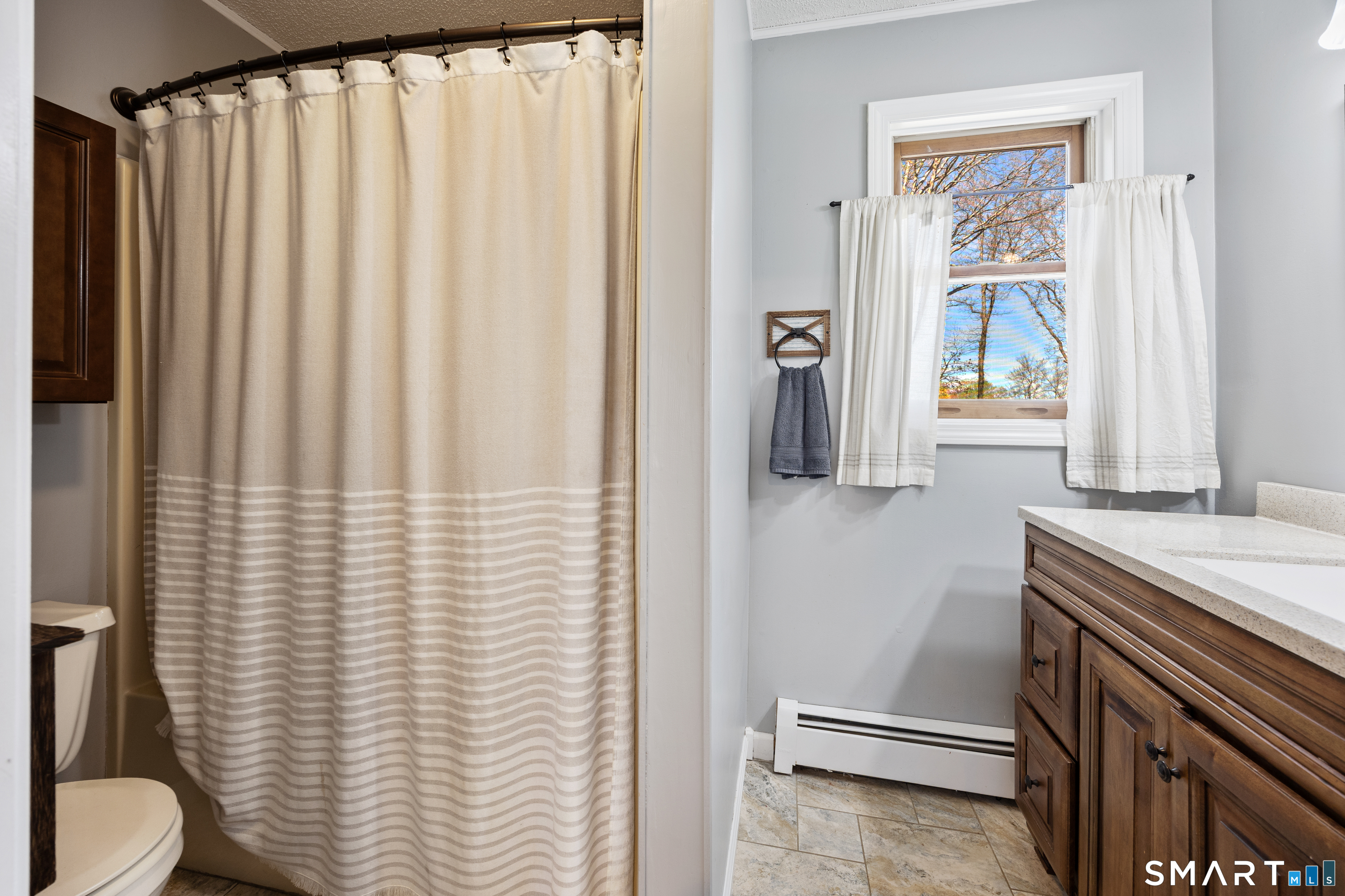16 Stephen Court Prospect, CT 06712 - Photo 21 of 39 a bathroom with a sink a toilet and a shower curtain