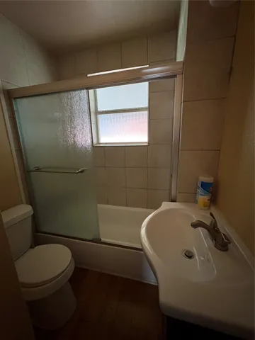a bathroom with a sink mirror toilet and bathtub