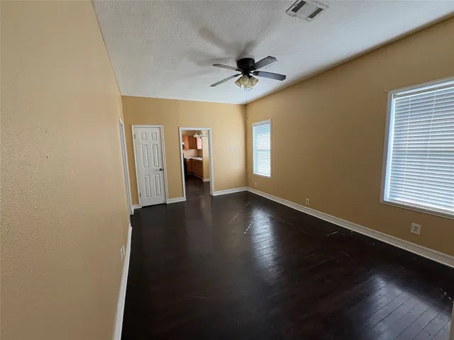 a view of a livingroom with a hardwood floor and a ceiling fan