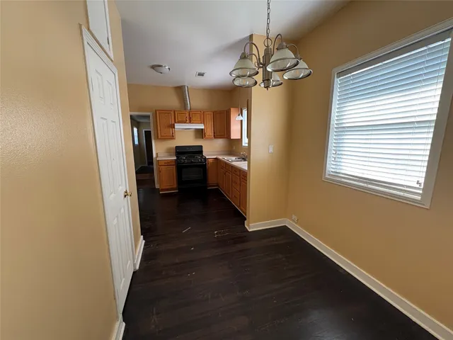 a view of a dining room with hardwood floor and a window