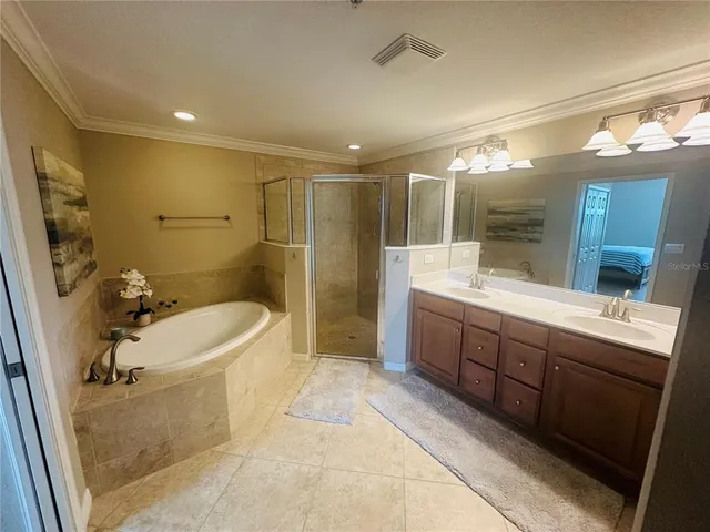 a bathroom with a tub sink shower and mirror
