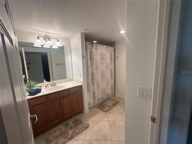 a bathroom with a double vanity sink mirror and shower
