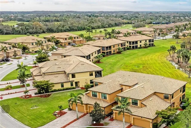 an aerial view of residential houses with outdoor space and river