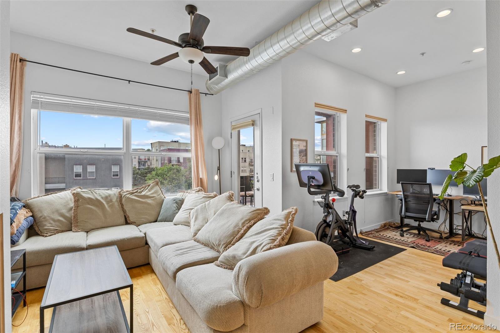 1555 Central Street, Unit 306 Denver, CO 80211 - Photo 11 of 36 a living room with furniture and a large window