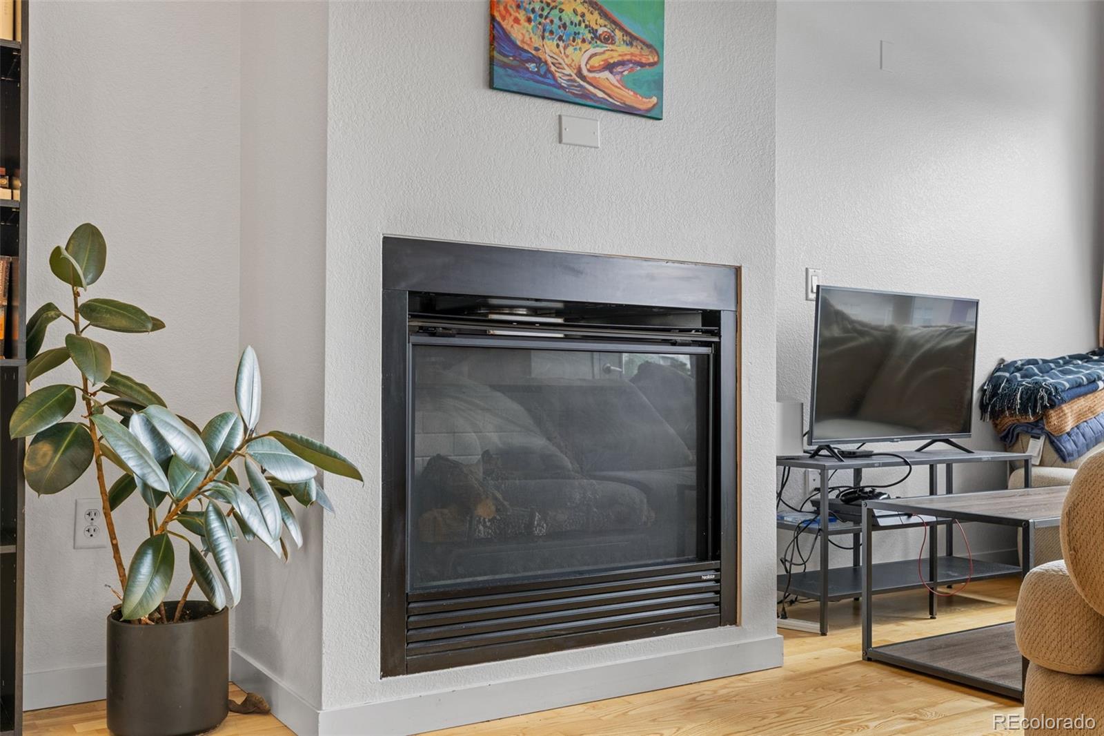1555 Central Street, Unit 306 Denver, CO 80211 - Photo 14 of 36 a living room with furniture and a potted plant