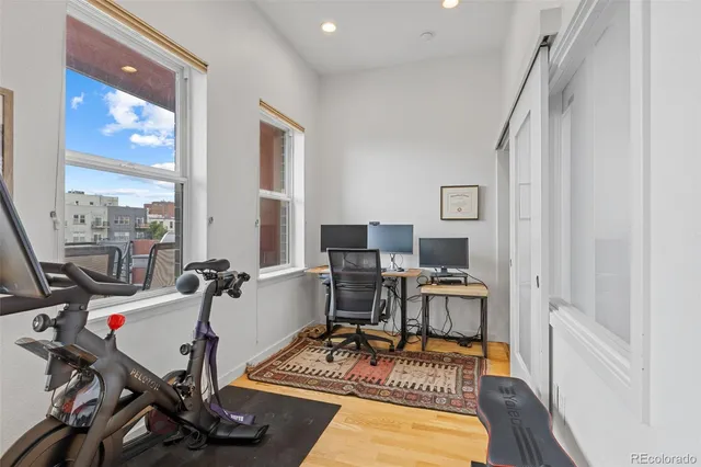 a view of a workspace with furniture and a window