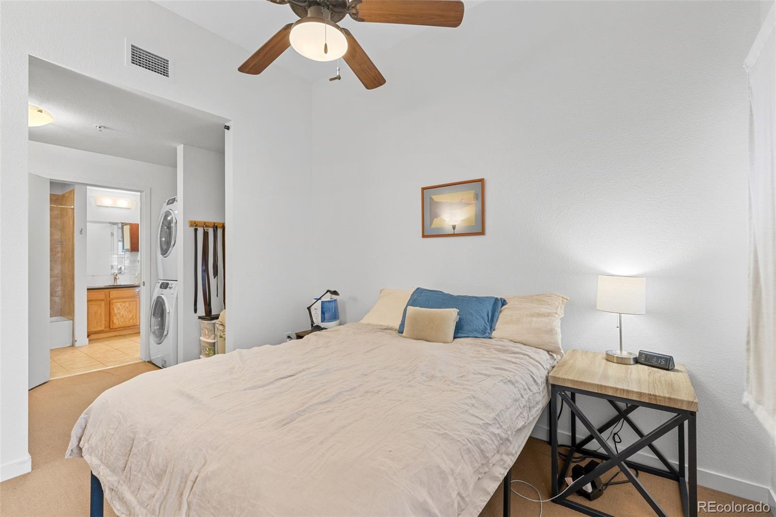 1555 Central Street, Unit 306 Denver, CO 80211 - Photo 24 of 36 a bedroom with a bed and a chandelier