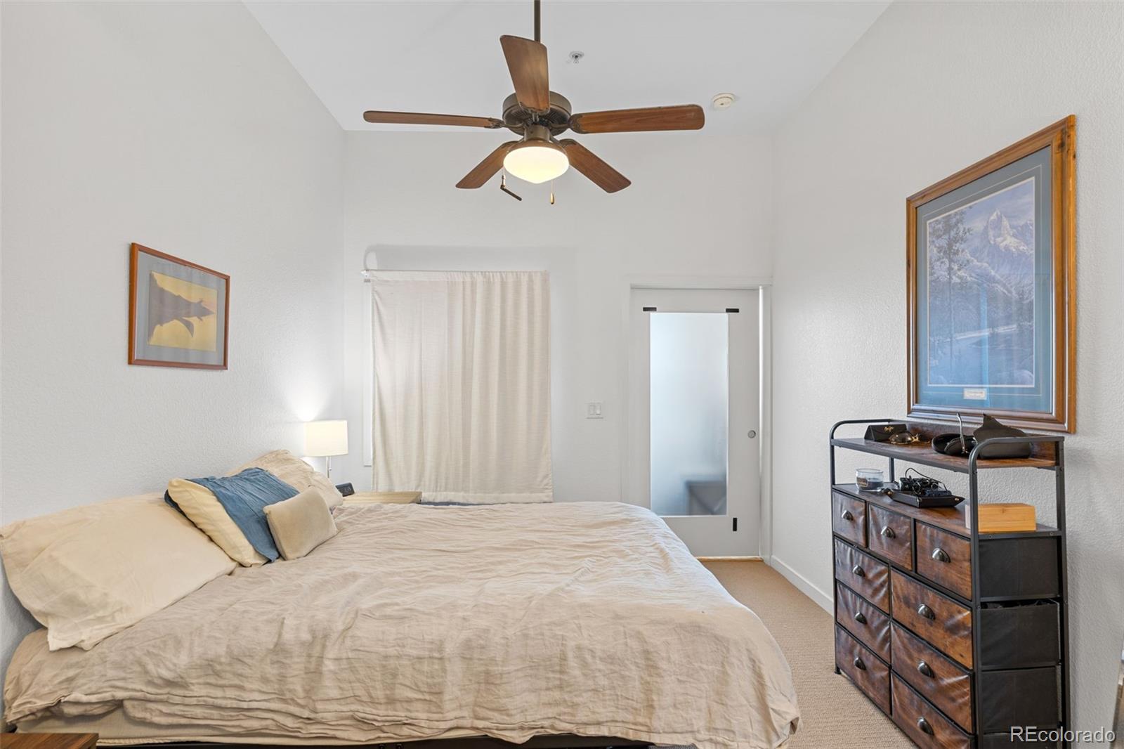 1555 Central Street, Unit 306 Denver, CO 80211 - Photo 25 of 36 a bedroom with a bed and a chandelier