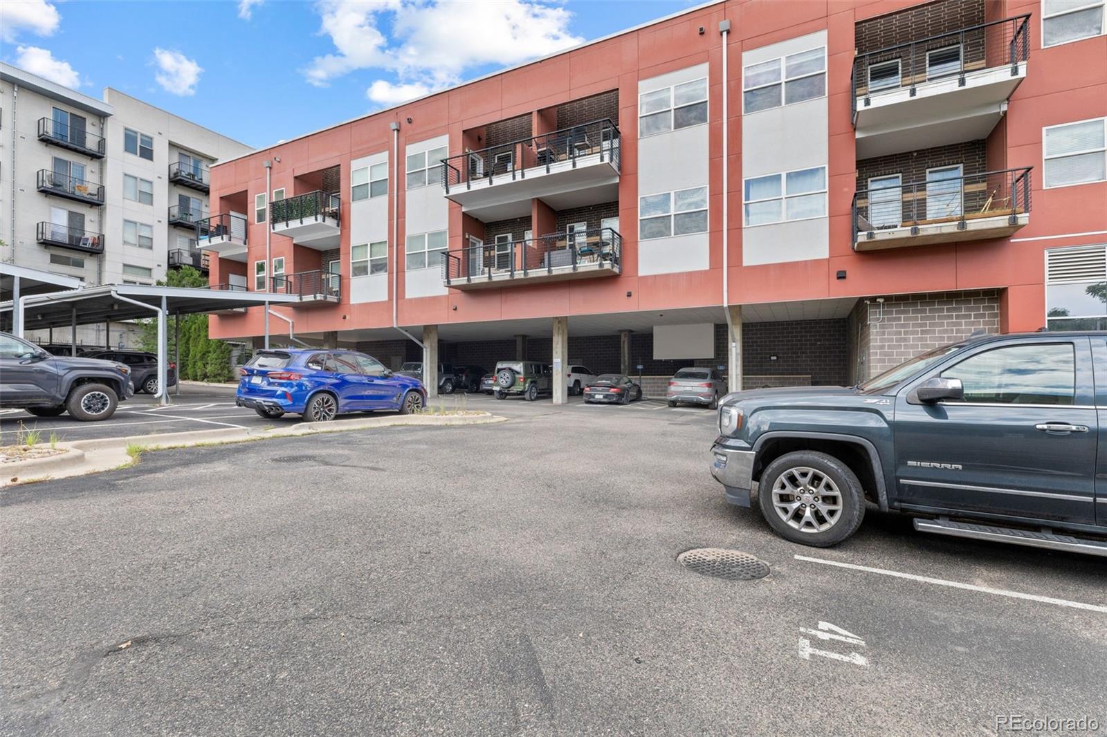 1555 Central Street, Unit 306 Denver, CO 80211 - Photo 34 of 36 a car parked in front of a building