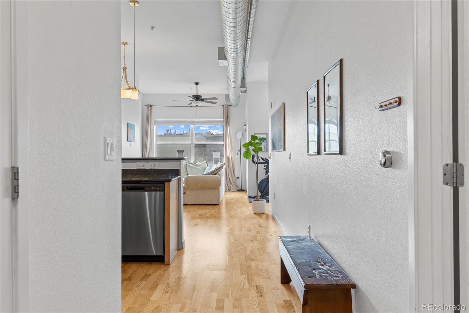 1555 Central Street, Unit 306 Denver, CO 80211 - Photo 9 of 36 a living room with furniture and a wooden floor
