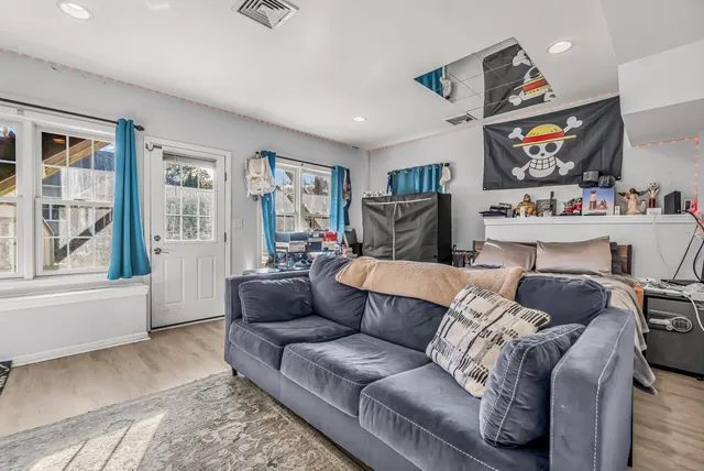 a living room with furniture and painting on the wall