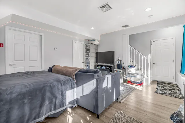 a bedroom with furniture and a flat screen tv