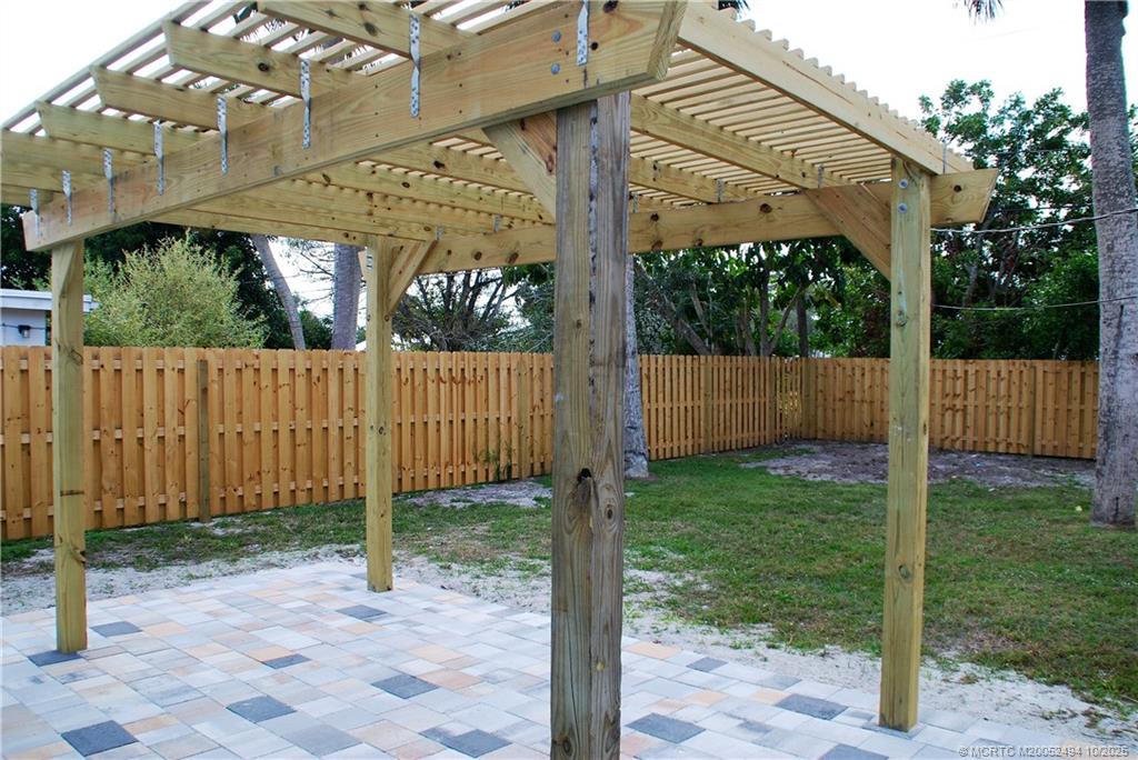 406 Robalo Court Stuart, FL 34996 - Photo 15 of 22 a view of a backyard with a fence