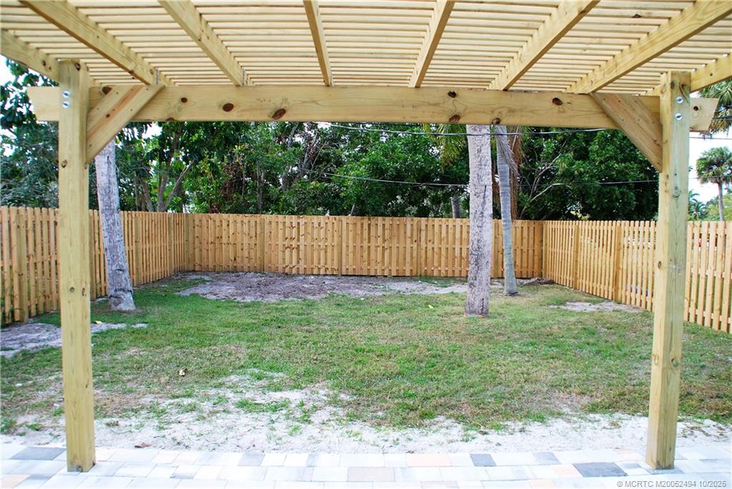406 Robalo Court Stuart, FL 34996 - Photo 17 of 22 a view of a backyard with a garden and plants