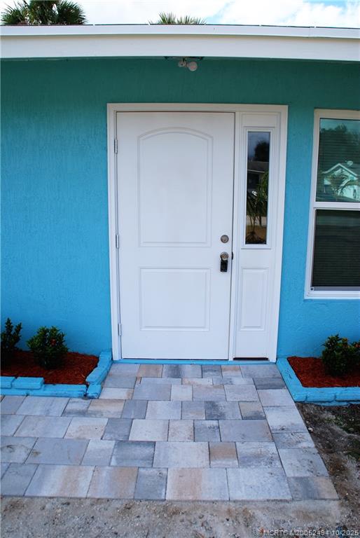 406 Robalo Court Stuart, FL 34996 - Photo 3 of 22 a view of a house with a yard