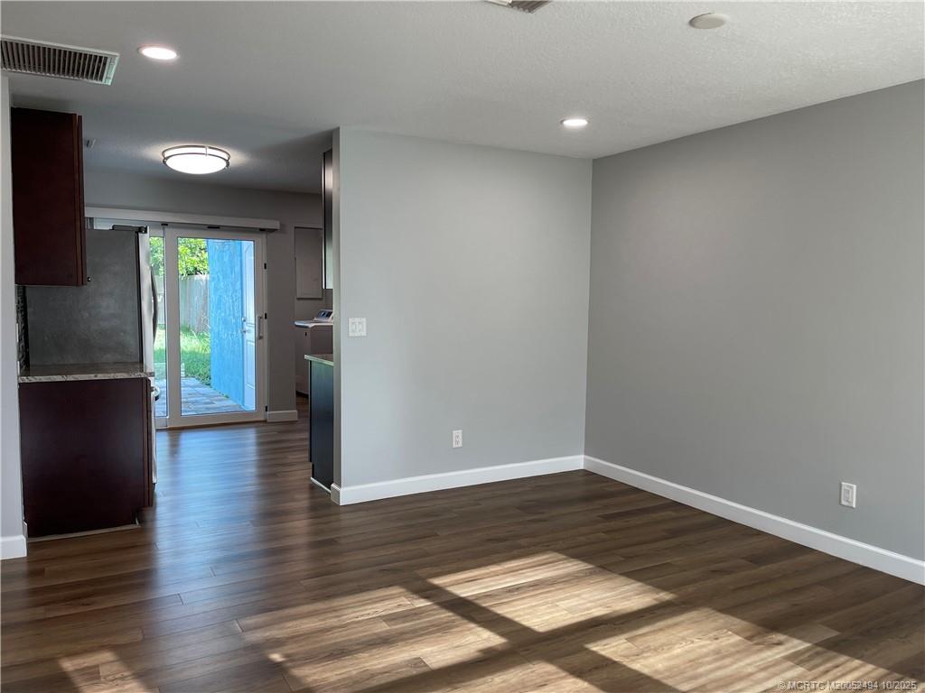 406 Robalo Court Stuart, FL 34996 - Photo 4 of 22 a view of a hallway with wooden floor and a living room