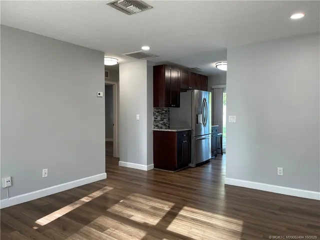 a kitchen with stainless steel appliances granite countertop wooden cabinets a stove top oven a sink and dishwasher